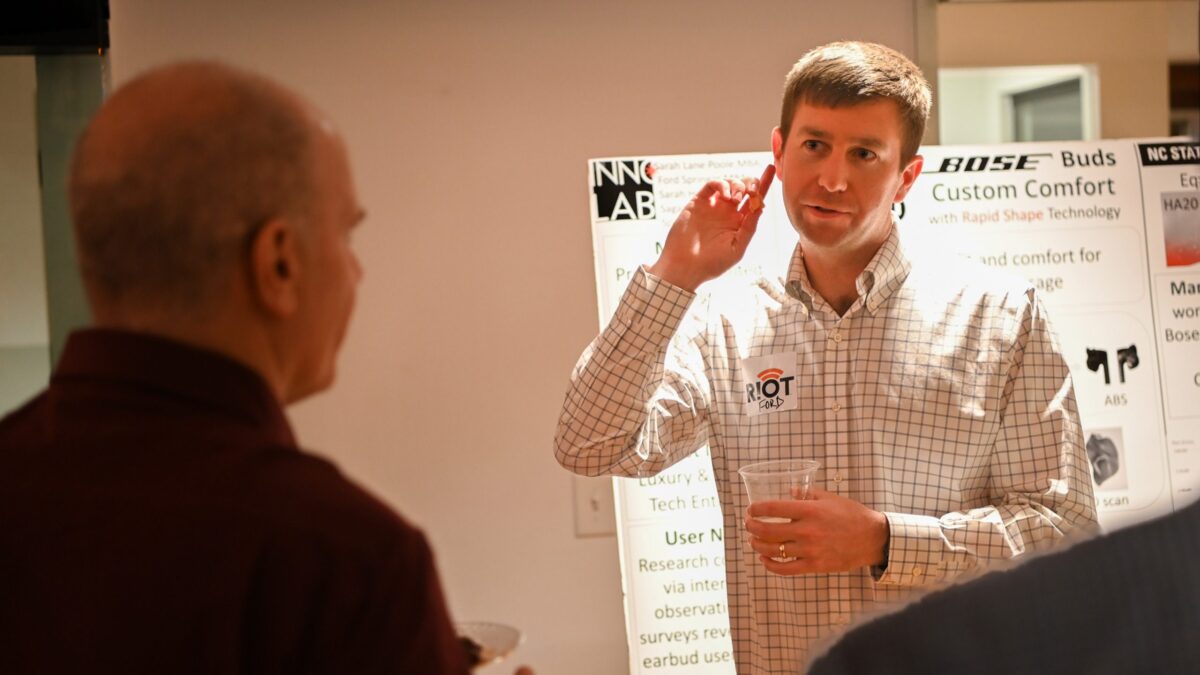 Ford Springer demonstrating the earbud to the judges