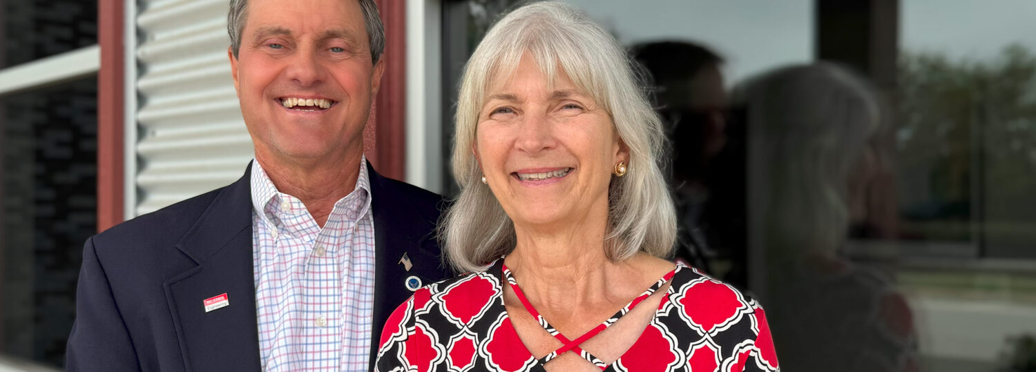 George and Grace Auten standing together outside of their company's building.