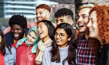 A diverse group of IMSE students smiling and having fun while submitting their student information.